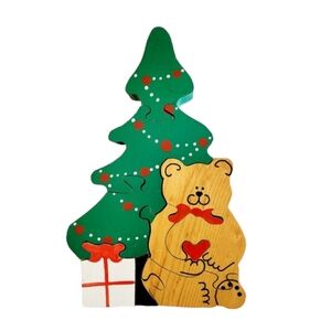 Handmade hand painted puzzle of bear sitting in front of Christmas tree